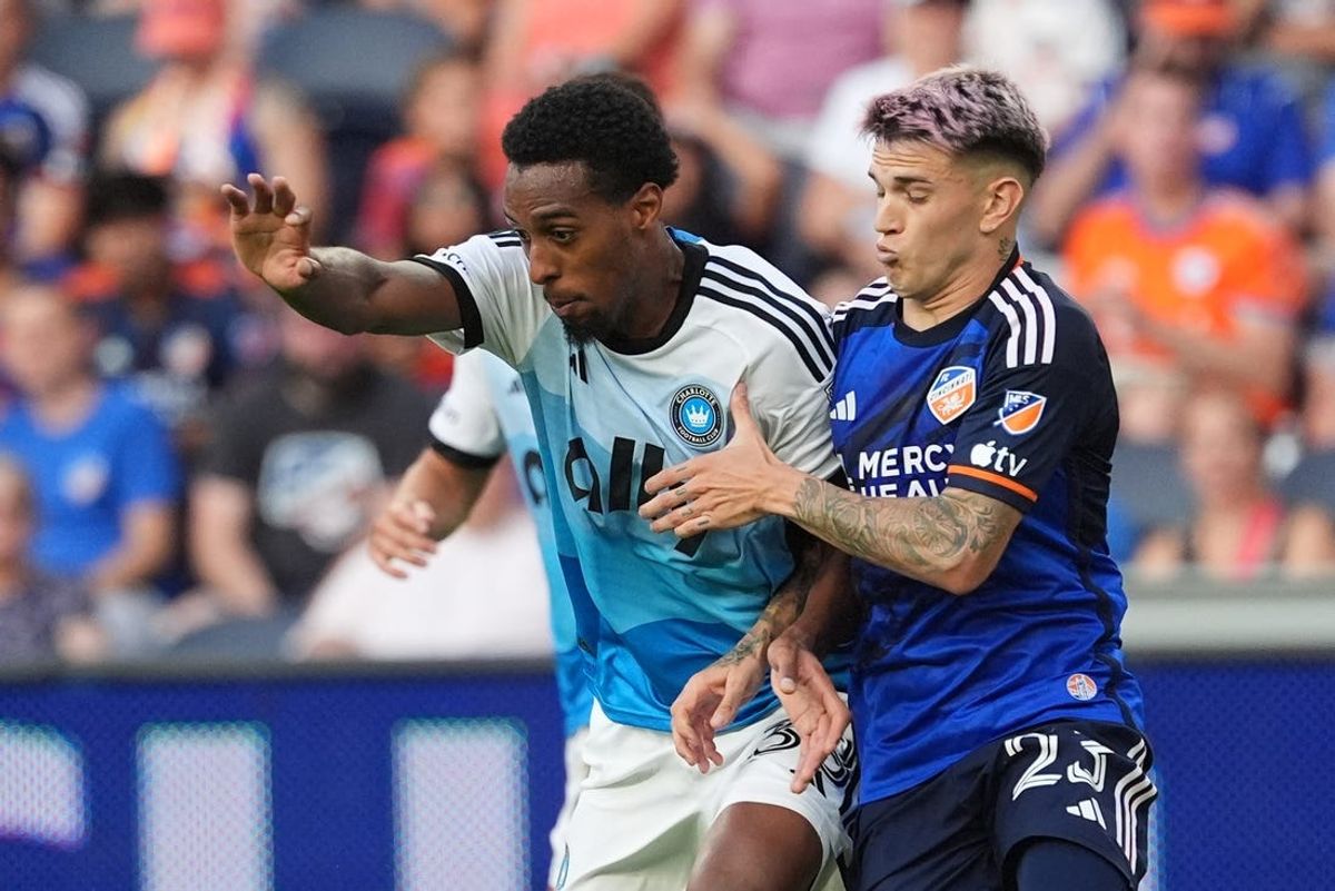 Jul 13, 2024; Cincinnati, Ohio, USA;  FC Cincinnati forward Luca Orellano (23) challenges Charlotte FC forward Iuri Tavares (38) during the first half at TQL Stadium. Mandatory Credit: Kareem Elgazzar-USA TODAY Sports