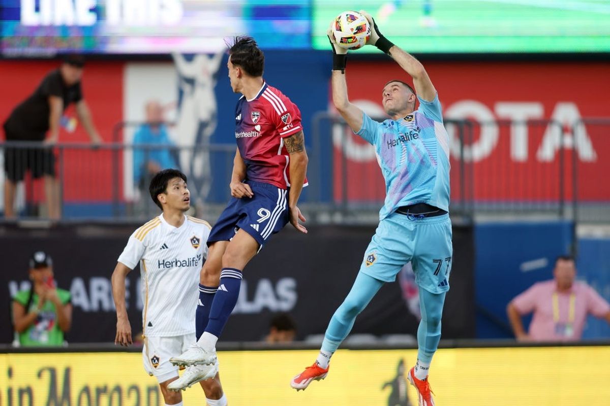 Jul 13, 2024; Frisco, Texas, USA; Los Angeles Galaxy goalkeeper John McCarthy (77) catches the ball against FC Dallas forward Petar Musa (9) in the first half at Toyota Stadium. Mandatory Credit: Tim Heitman-USA TODAY Sports