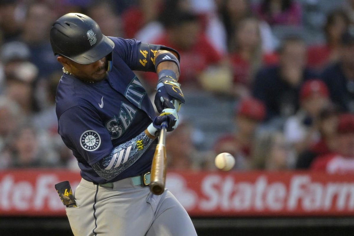 Jul 13, 2024; Anaheim, California, USA;  Julio Rodriguez #44 of the Seattle Mariners singles in the fifth inning against the Los Angeles Angels at Angel Stadium. Mandatory Credit: Jayne Kamin-Oncea-USA TODAY Sports
