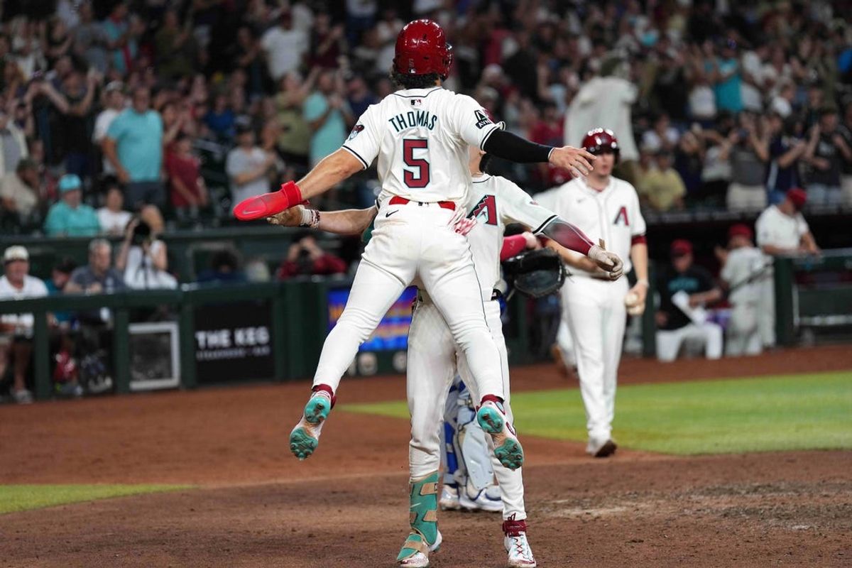 Jul 13, 2024; Phoenix, Arizona, USA; Arizona Diamondbacks outfielder Corbin Carroll (7) bumps chests with Arizona Diamondbacks outfielder Alek Thomas (5) after hitting a two run home run against the Toronto Blue Jays during the eighth inning at Chase Field. Mandatory Credit: Joe Camporeale-USA TODAY Sports