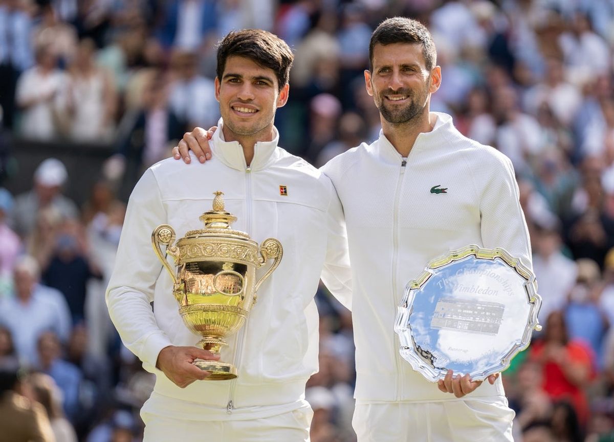 Jul 14, 2024; London, United Kingdom; Carlos Alcaraz of Spain and Novak Djokovic of Serbia pose with their trophies after the men’s singles final on day 14 at All England Lawn Tennis and Croquet Club. Mandatory Credit: Susan Mullane-Imagn Images