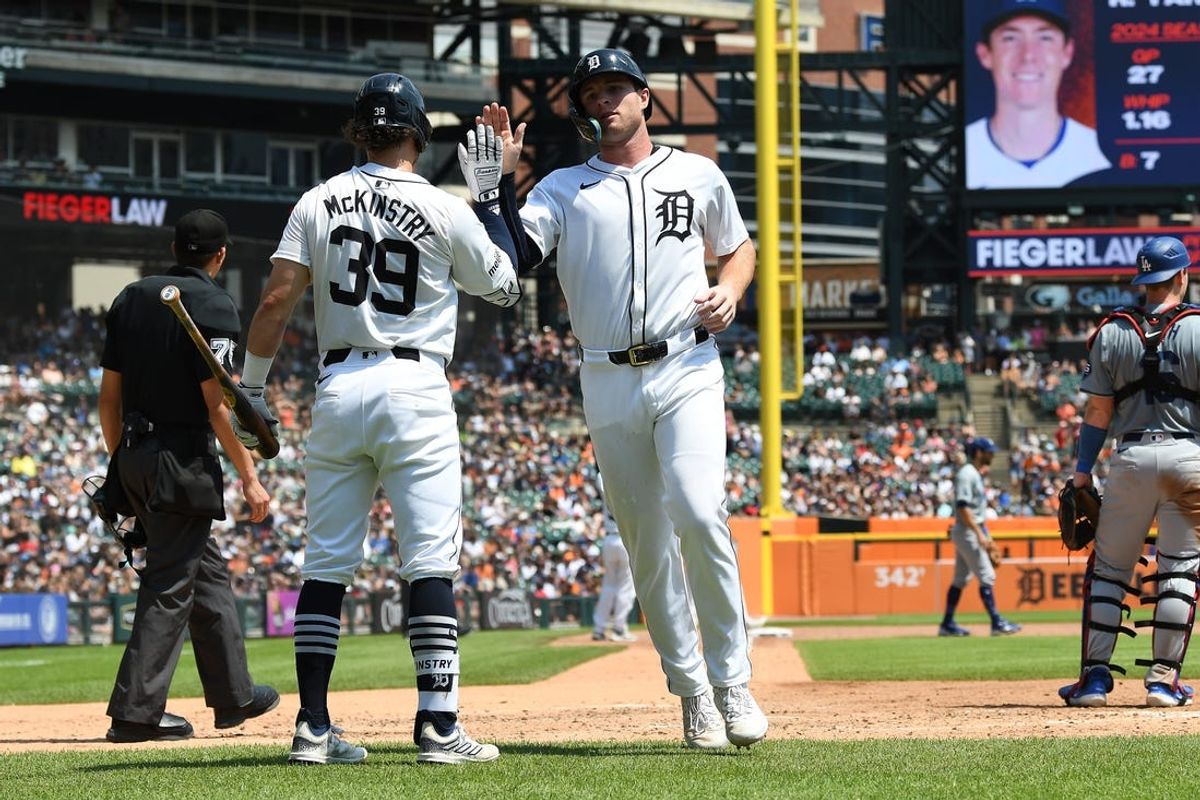 Jul 14, 2024; Detroit, Michigan, USA;  Detroit Tigers second baseman Colt Keith (33) celebrates with shortstop Zach McKinstry (39) after scoring on a sacrifice fly by third baseman Gio Urshela (not pictured) against the Los Angeles Dodgers in the fourth inning at Comerica Park. Mandatory Credit: Lon Horwedel-USA TODAY Sports