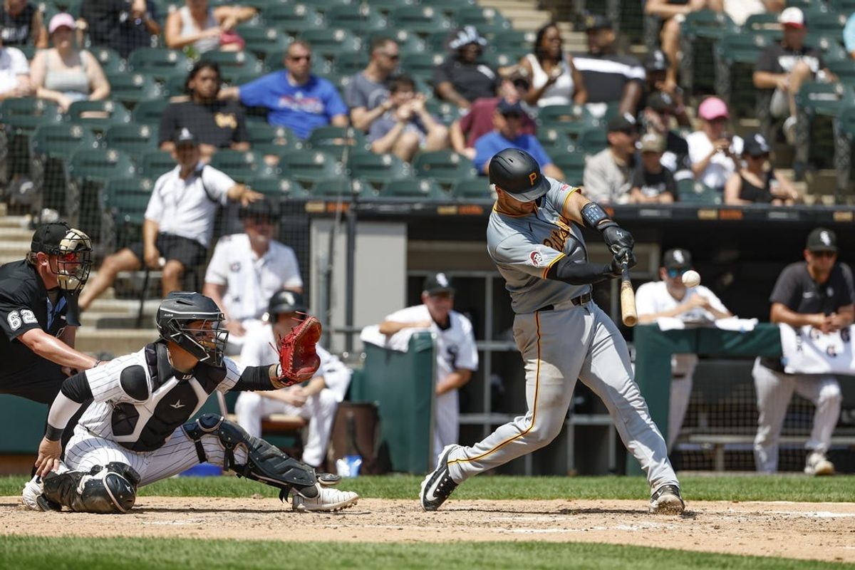Jul 14, 2024; Chicago, Illinois, USA; Pittsburgh Pirates catcher Joey Bart (14) hits a three-run home run against the Chicago White Sox during the fourth inning at Guaranteed Rate Field. Mandatory Credit: Kamil Krzaczynski-USA TODAY Sports