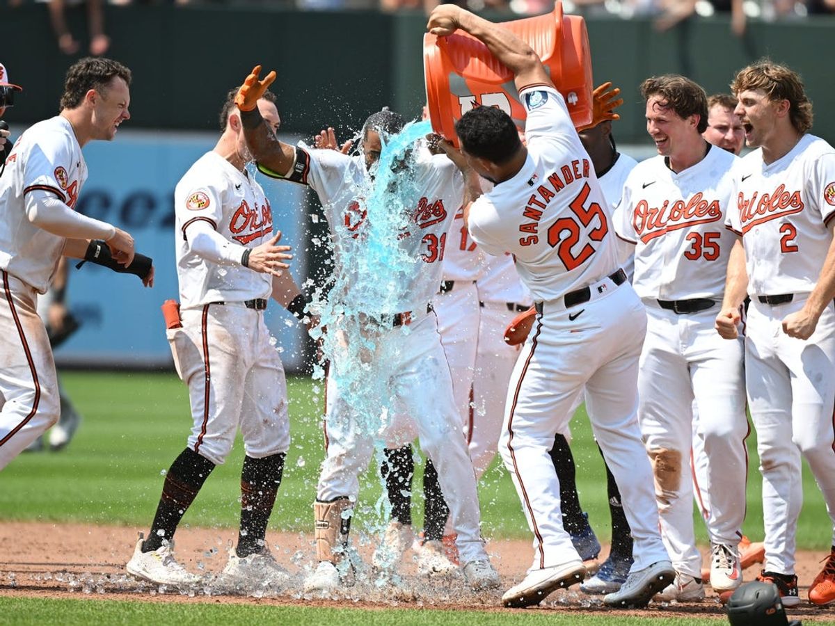 Jul 14, 2024; Baltimore, Maryland, USA;  Baltimore Orioles outfielder Cedric Mullins (31), Anthony Santander (25) and teammates celebrate a walk-off win against the New York Yankees at Oriole Park at Camden Yards. Mandatory Credit: James A. Pittman-USA TODAY Sports