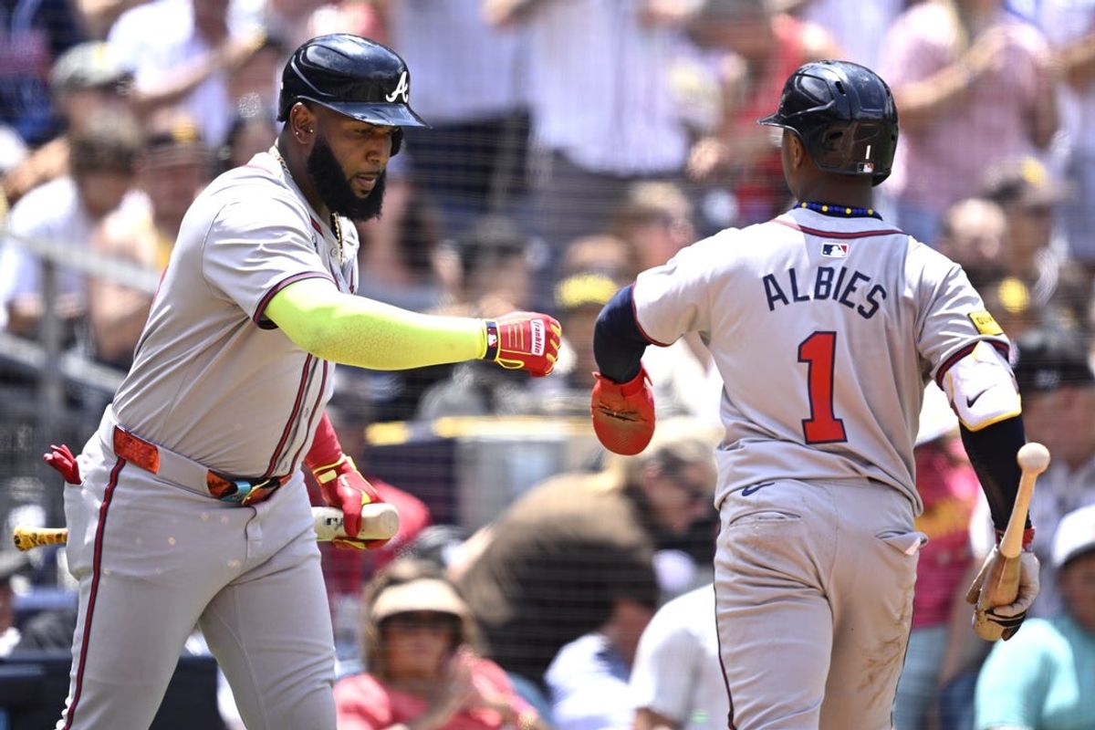 Jul 14, 2024; San Diego, California, USA; Atlanta Braves second baseman Ozzie Albies (1) is congratulated by designated hitter Marcell Ozuna (20) after scoring a run against the San Diego Padres during the fourth inning at Petco Park. Mandatory Credit: Orlando Ramirez-USA TODAY Sports