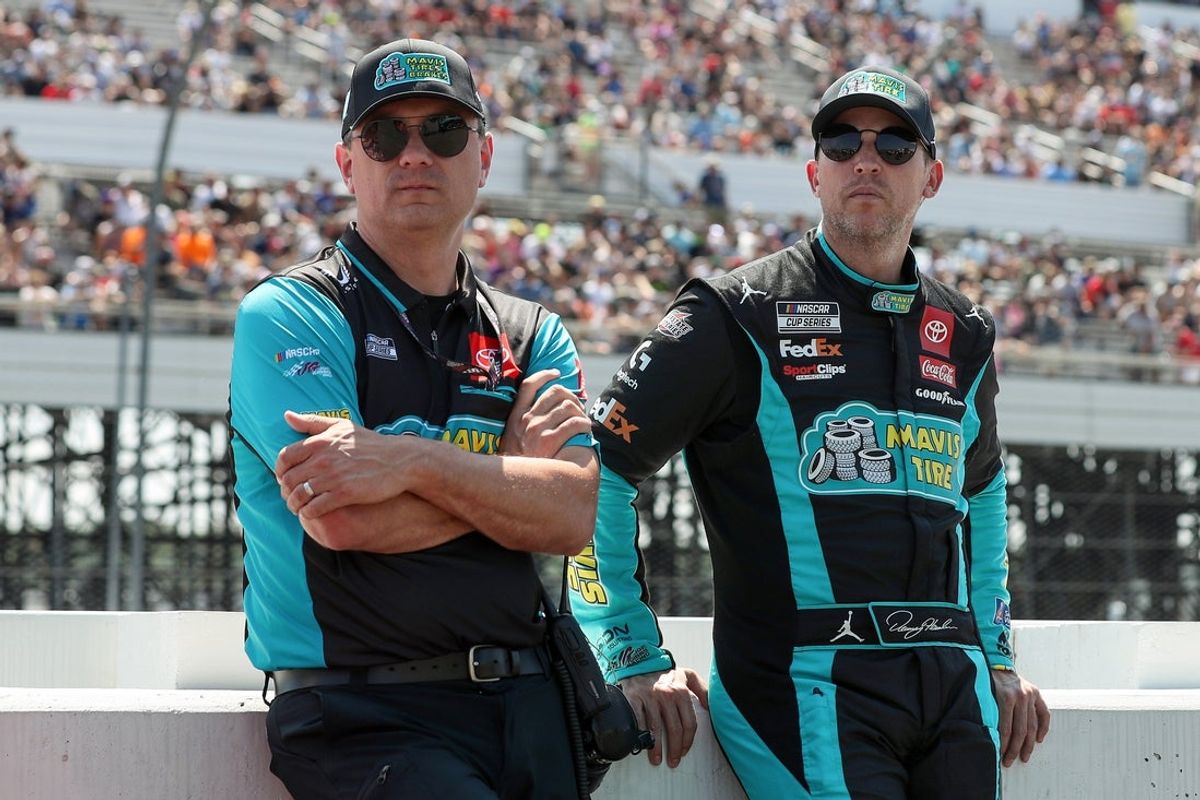 Jul 14, 2024; Long Pond, Pennsylvania, USA; NASCAR Cup Series driver Denny Hamlin (right) stands with his crew chief Chris Gabehart (left) on pit road prior to The Great American Getaway 400 at Pocono Raceway. Mandatory Credit: Matthew O'Haren-Imagn Images
