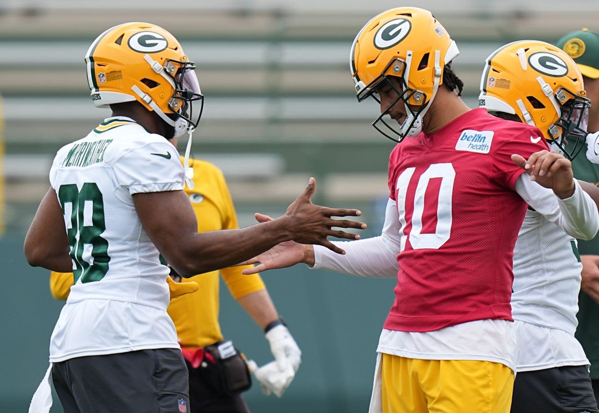 Green Bay Packers quarterback Jordan Love (10) clowns around with running back Ellis Merriweather(38) during organized team activities Tuesday, May 21, 2024 in Green Bay, Wisconsin.