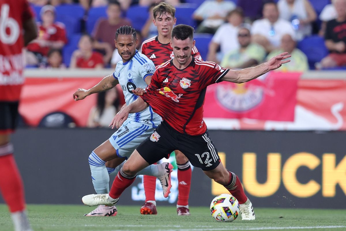 Jul 17, 2024; Harrison, New Jersey, USA; CF Montreal forward Ariel Lassiter (11) fights for the ball against New York Red Bulls defender Dylan Nealis (12) during the first half at Red Bull Arena. Mandatory Credit: Brad Penner-USA TODAY Sports