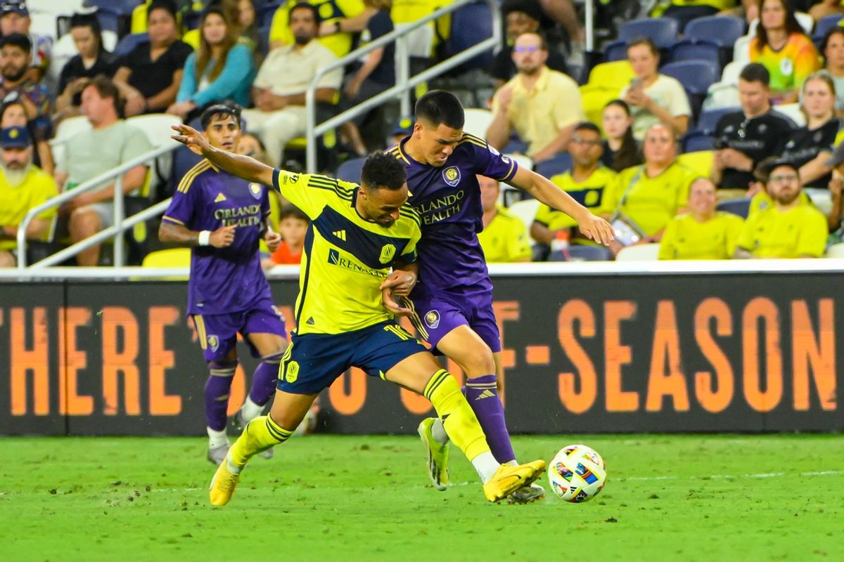 Jul 17, 2024; Nashville, Tennessee, USA; Nashville SC midfielder Hany Mukhtar (10) dribbles the ball past Orlando City SC midfielder Cesar Araujo (5) during the second half at Geodis Park. Mandatory Credit: Steve Roberts-USA TODAY Sports
