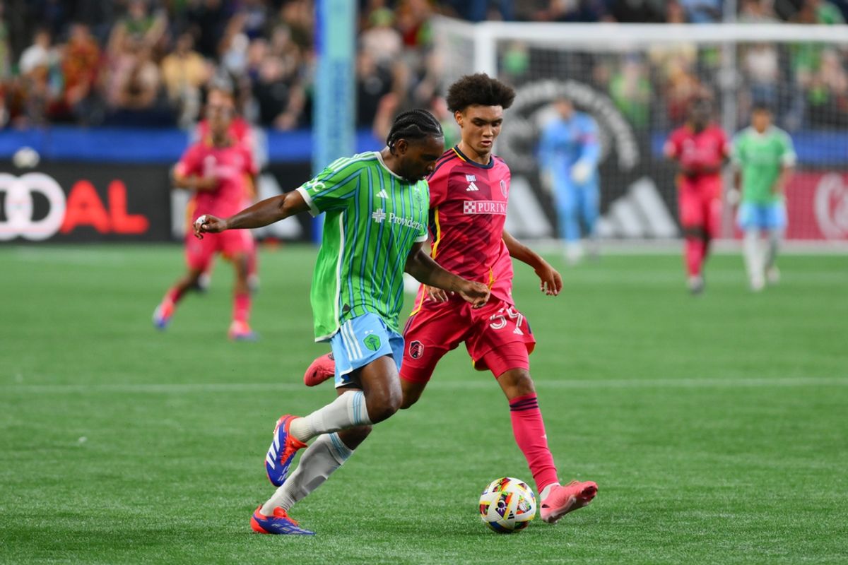 Jul 17, 2024; Seattle, Washington, USA; Seattle Sounders FC defender Jonathan Bell (15) and St. Louis CITY SC forward Mykhi Joyner (59) play the loose ball during the second half at Lumen Field. Mandatory Credit: Steven Bisig-USA TODAY Sports