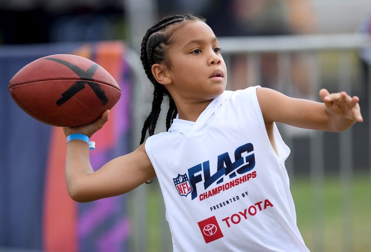 Taj Holeman, 8, of Texas tries his arm at the NFL Experience during the 2024 NFL Flag Championships games at ForeverLawn Sports Complex. Thursday, July 18, 2024.
