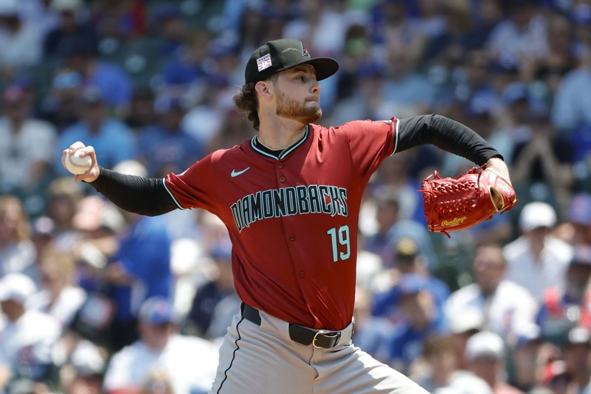 Jul 19, 2024; Chicago, Illinois, USA; Arizona Diamondbacks starting pitcher Ryne Nelson (19) delivers a pitch against the Chicago Cubs during the first inning at Wrigley Field. Mandatory Credit: Kamil Krzaczynski-USA TODAY Sports