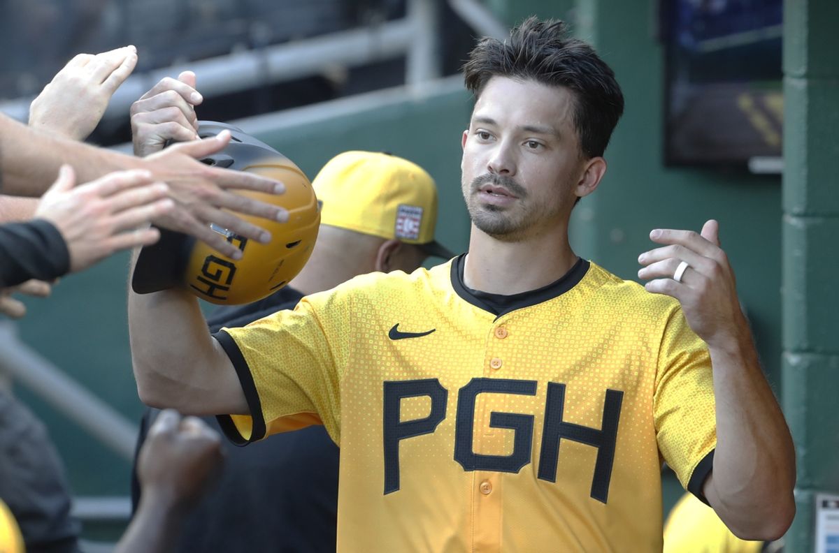 Jul 19, 2024; Pittsburgh, Pennsylvania, USA;  Pittsburgh Pirates left fielder Bryan Reynolds (10) celebrates in the dugout after scoring a run against the Philadelphia Phillies during the first inning at PNC Park. Mandatory Credit: Charles LeClaire-USA TODAY Sports