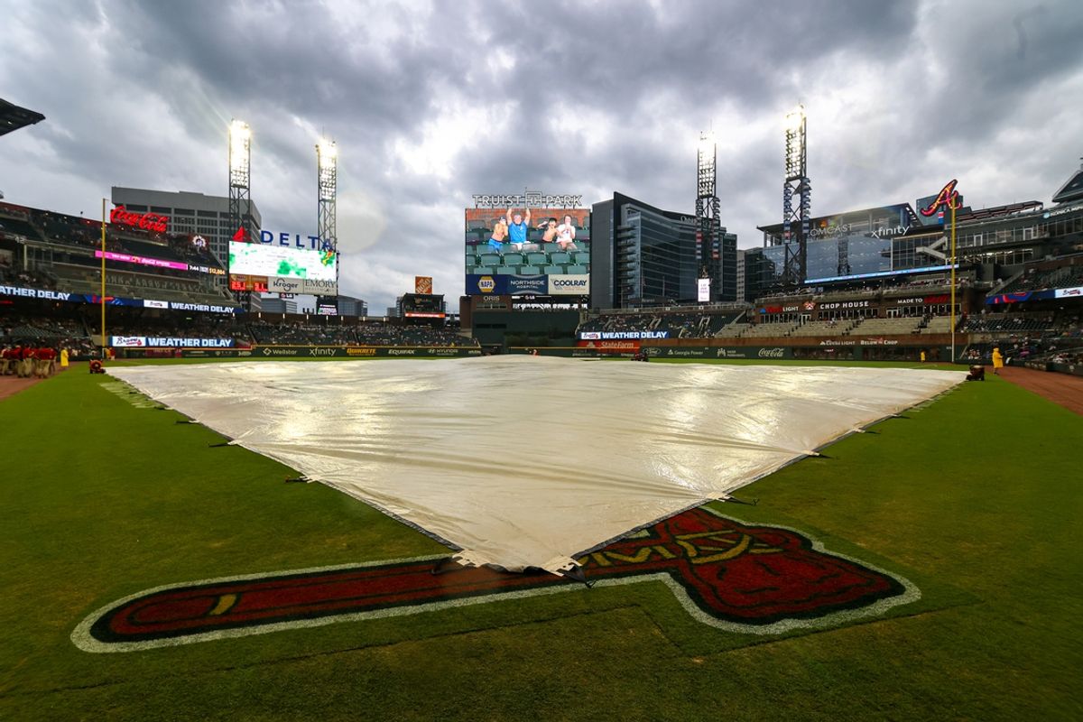 Jul 19, 2024; Atlanta, Georgia, USA; A tarp on the field during a weather delay before a game between the Atlanta Braves and St. Louis Cardinals at Truist Park. Mandatory Credit: Brett Davis-USA TODAY Sports