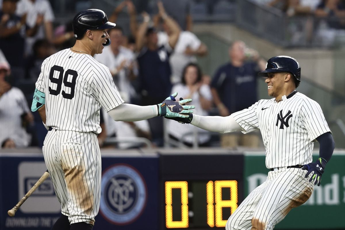 Jul 19, 2024; Bronx, New York, USA;  New York Yankees right fielder Juan Soto (22) is greeted by designated hitter Aaron Judge (99) after scoring in the fourth inning against the Tampa Bay Rays at Yankee Stadium. Mandatory Credit: Wendell Cruz-USA TODAY Sports