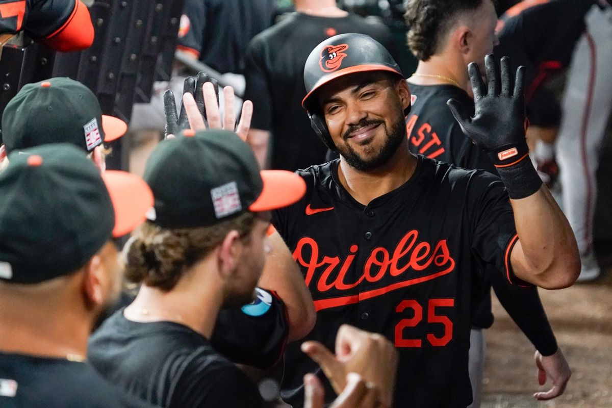Jul 19, 2024; Arlington, Texas, USA; Baltimore Orioles outfielder Anthony Santander (25) is greeted in the dugout after hitting a three-run home run during the seventh inning against the Texas Rangers at Globe Life Field. Mandatory Credit: Raymond Carlin III-USA TODAY Sports
