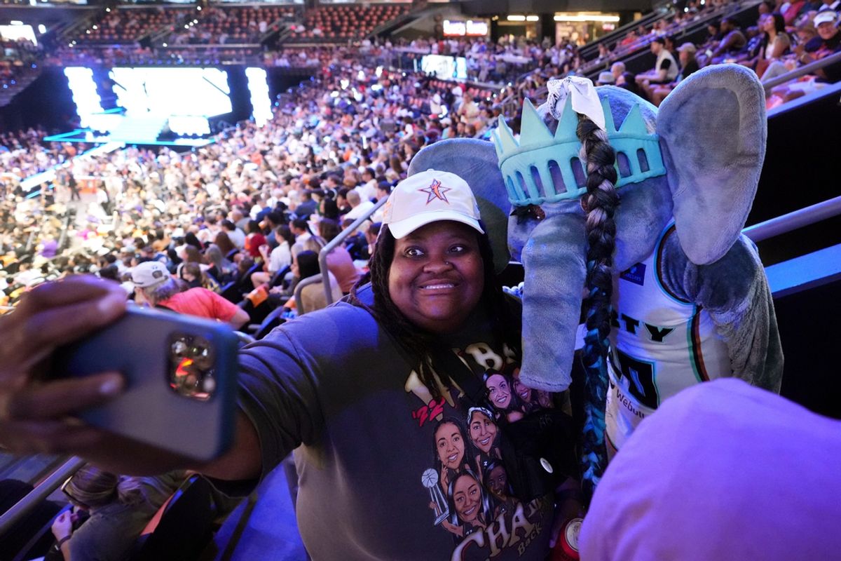 New York Liberty mascot Ellie the Elephant takes a photo with fan Sheena O during the WNBA All-Star Game Skills Challenge at Footprint Center in Phoenix on Friday, July 19, 2024.