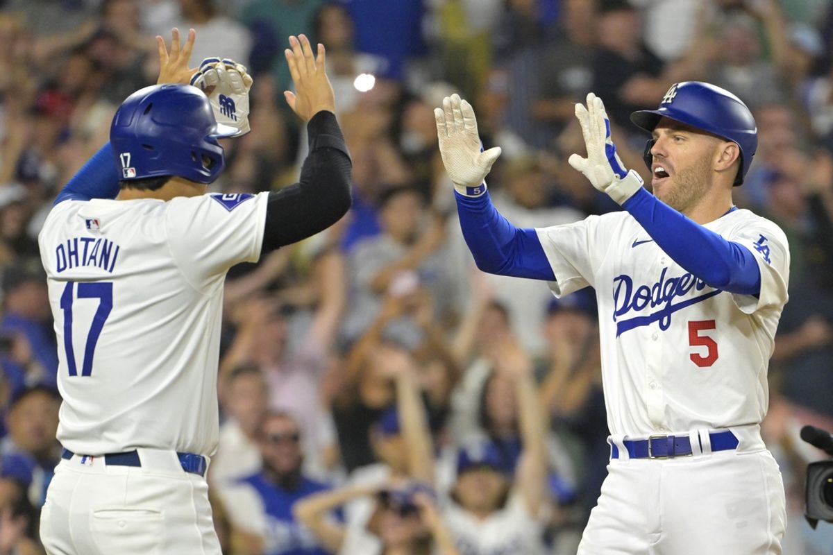 Jul 19, 2024; Los Angeles, California, USA;  Los Angeles Dodgers first base Freddie Freeman (5) is congratulated by designated hitter Shohei Ohtani (17) after hitting a grand slam home run in the eighth inning against the Boston Red Sox at Dodger Stadium. Mandatory Credit: Jayne Kamin-Oncea-USA TODAY Sports