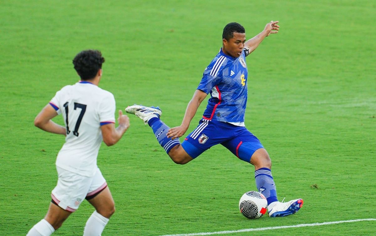 Jun 11, 2024; Kansas City, Kansas, USA; Japan midfielder Joel Chima Fujita (8) kicks the ball against United States forward Johan Gomez (17) during the first half at Children's Mercy Park. Mandatory Credit: Jay Biggerstaff-Imagn Images