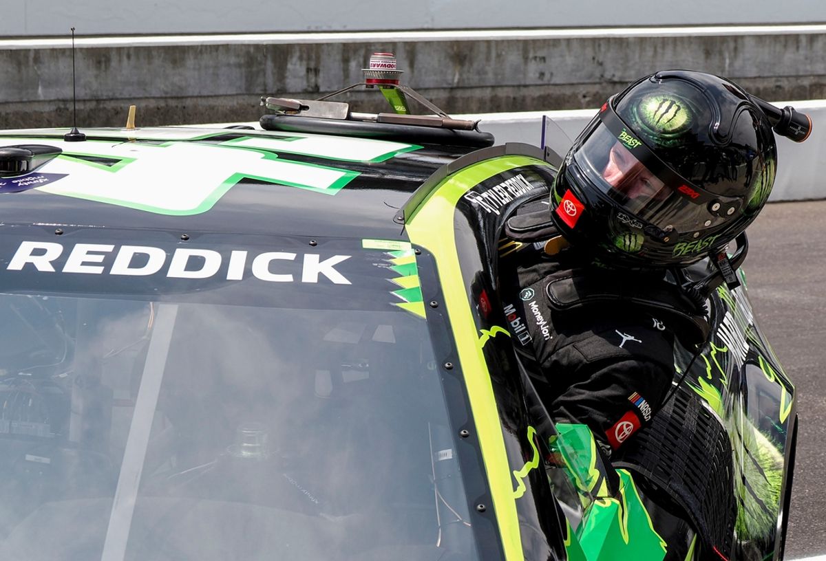 NASCAR Cup Series driver Tyler Reddick (45) climbs out of his car after qualifying on pole position for the Brickyard 400, Saturday, July 20, 2024, at Indianapolis Motor Speedway.