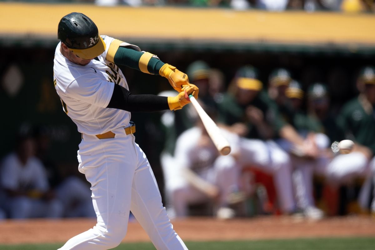 Jul 20, 2024; Oakland, California, USA; Oakland Athletics designated hitter Brent Rooker (25) connects for a single against the Los Angeles Angels during the fourth inning at Oakland-Alameda County Coliseum. Mandatory Credit: D. Ross Cameron-USA TODAY Sports