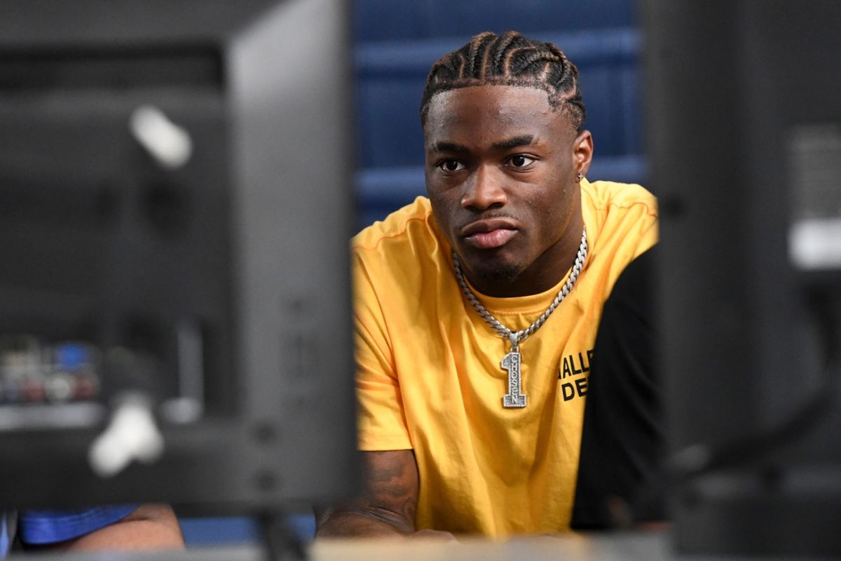 Alabama quarterback Jalen Milroe reacts as he plays the new EA Sports College Football 25 video game with young people at the McDonald Hughes Center in Tuscaloosa. Milroe is one of the players featured on the game’s cover.