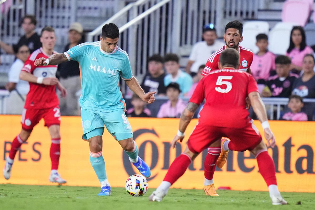 Jul 20, 2024; Fort Lauderdale, Florida, USA; Inter Miami CF forward Luis Suarez (9) controls the ball against Chicago Fire FC defender Rafael Czichos (5) in the first half at Chase Stadium. Mandatory Credit: Rich Storry-USA TODAY Sports