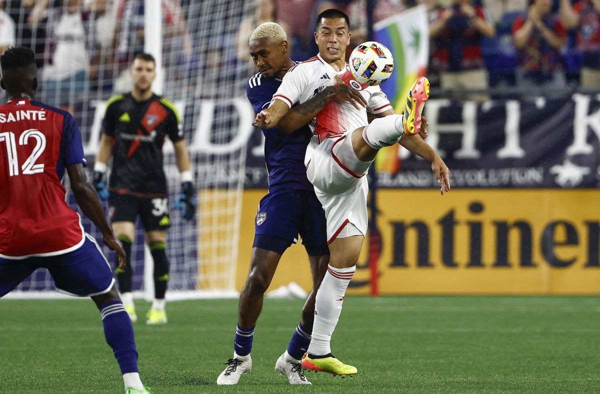 Jul 20, 2024; Foxborough, Massachusetts, USA; New England Revolution forward Bobby Wood (17) clears the ball away from FC Dallas defender Nkosi Tafari (17) during the first half at Gillette Stadium. Mandatory Credit: Winslow Townson-USA TODAY Sports