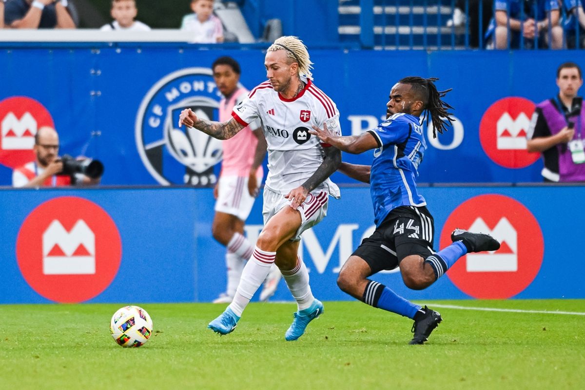 Jul 20, 2024; Montreal, Quebec, CAN; CF Montreal defender Raheem Edwards (44) tackles Toronto FC forward Federico Bernardeschi (10) during the first half at Stade Saputo. Mandatory Credit: David Kirouac-USA TODAY Sports