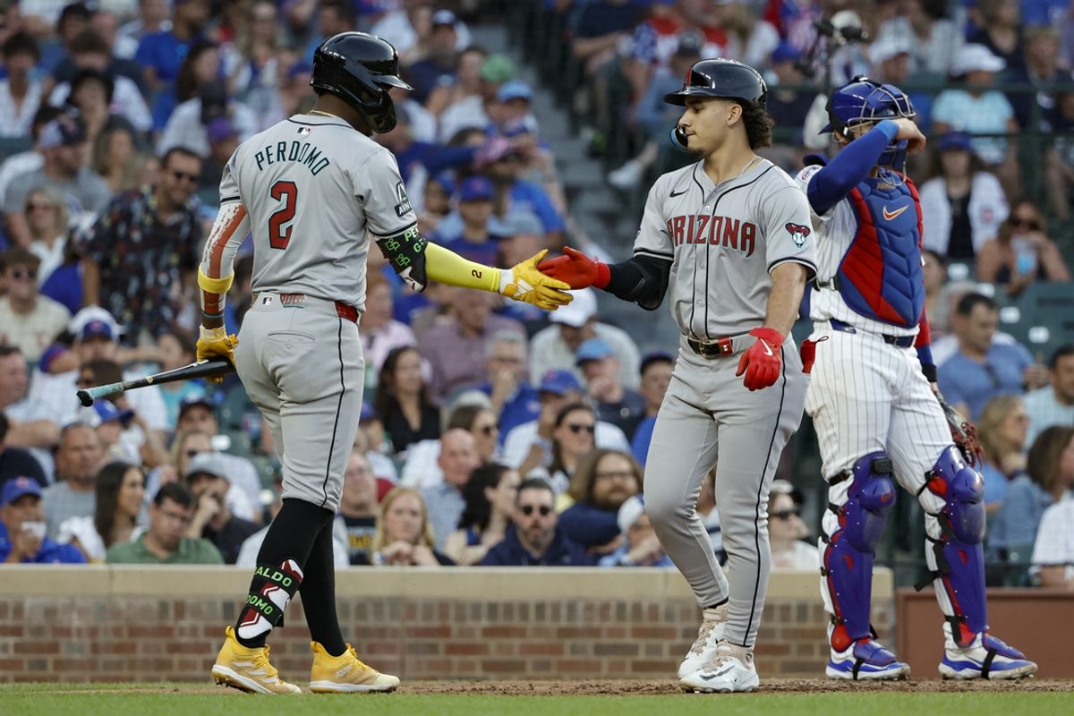 Jul 20, 2024; Chicago, Illinois, USA; Arizona Diamondbacks outfielder Alek Thomas (5) celebrates with shortstop Geraldo Perdomo (2) after hitting a solo home run against the Chicago Cubs during the fifth inning at Wrigley Field. Mandatory Credit: Kamil Krzaczynski-USA TODAY Sports