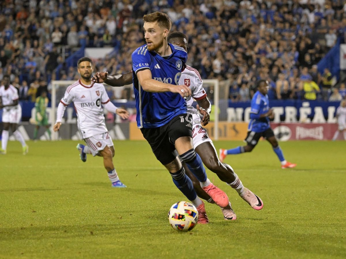 Jul 20, 2024; Montreal, Quebec, CAN; CF Montreal defender Joel Waterman (16) plays the ball and Toronto FC midfielder Richie Laryea (22) defends during the second half at Stade Saputo. Mandatory Credit: Eric Bolte-USA TODAY Sports