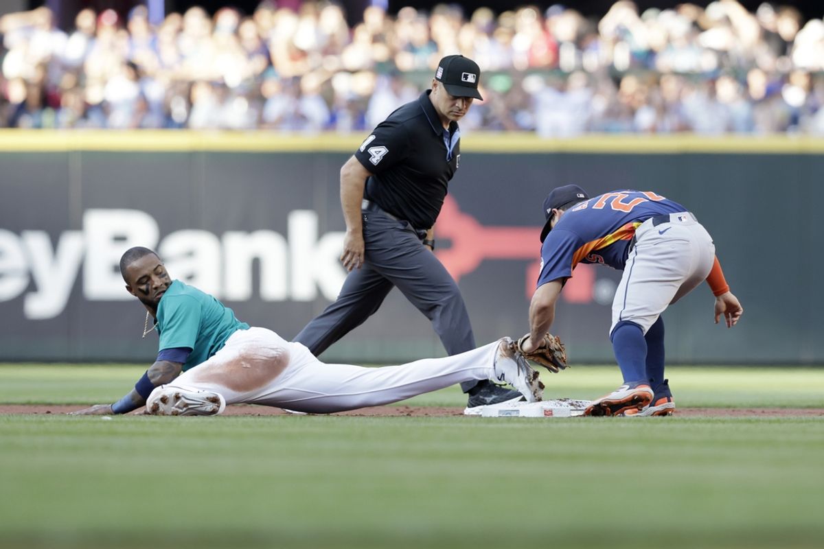 Jul 20, 2024; Seattle, Washington, USA; Seattle Mariners left fielder Victor Robles (10) steals second base against Houston Astros second baseman Jose Altuve (27) during the first inning at T-Mobile Park. Mandatory Credit: John Froschauer-USA TODAY Sports
