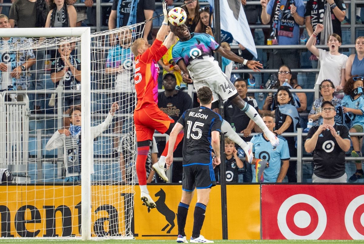 Jul 20, 2024; Saint Paul, Minnesota, USA; Minnesota United forward Tanitoluwa Oluwaseyi (14) challenges San Jose Earthquakes goalkeeper William Yarbrough (25) in the second half at Allianz Field. Mandatory Credit: Matt Blewett-USA TODAY Sports