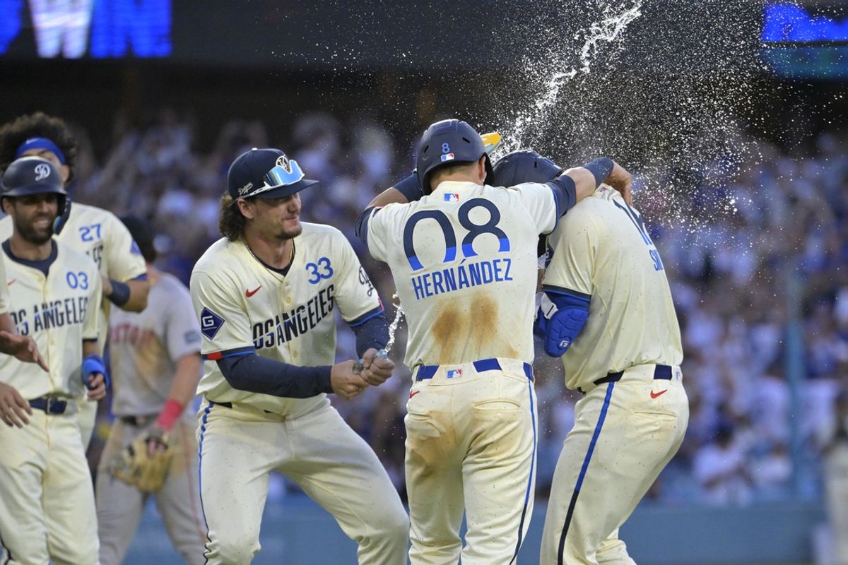 Jul 20, 2024; Los Angeles, California, USA;  Los Angeles Dodgers center fielder James Outman (33) and third baseman Enrique Hernandez (8) celebrate with catcher Will Smith (16) after he hit a walk-off single to defeat the Boston Red Sox in the 11th inning at Dodger Stadium. Mandatory Credit: Jayne Kamin-Oncea-USA TODAY Sports