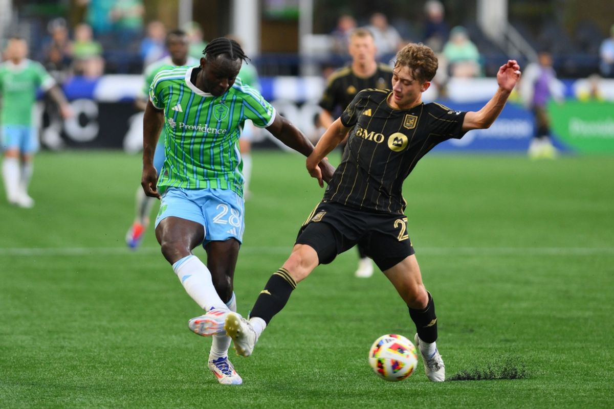 Jul 20, 2024; Seattle, Washington, USA; Seattle Sounders FC defender Yeimar (28) and LAFC forward Nathan Ordaz (27) battle for the ball in the first half at Lumen Field. Mandatory Credit: Steven Bisig-USA TODAY Sports