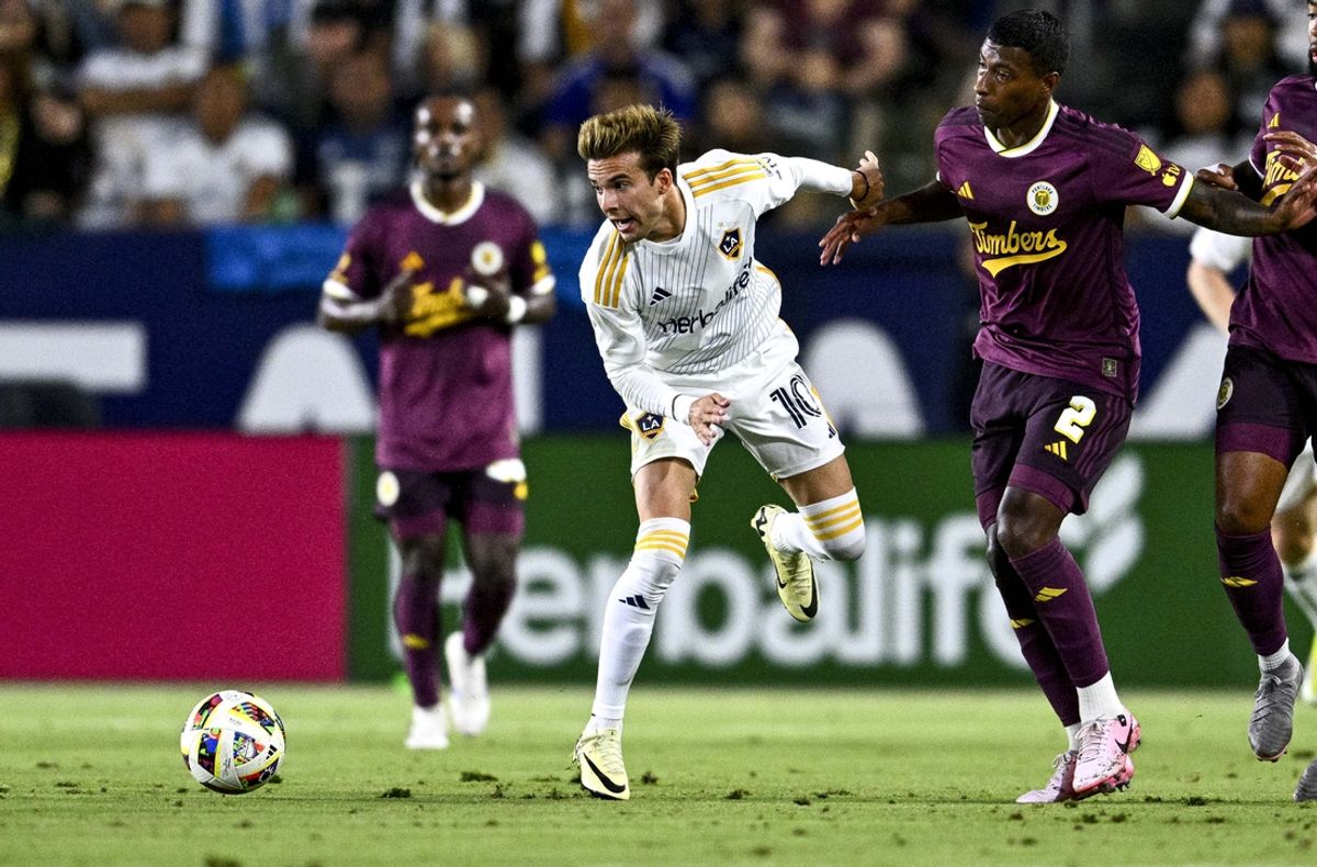 Jul 20, 2024; Carson, California, USA; Portland Timbers defender Miguel Araujo (2) and LA Galaxy midfielder Riqui Puig (10) battle for the ball during their MLS soccer match at Dignity Health Sports Park. Mandatory Credit: Kelvin Kuo-USA TODAY Sports