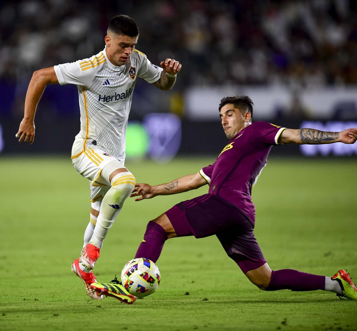 Jul 20, 2024; Carson, California, USA; LA Galaxy forward Gabriel Pec (11) moves the ball past Portland Timbers defender Claudio Bravo (5) in the second half of their MLS soccer match at Dignity Health Sports Park. Mandatory Credit: Gary A. Vasquez-Imagn Images