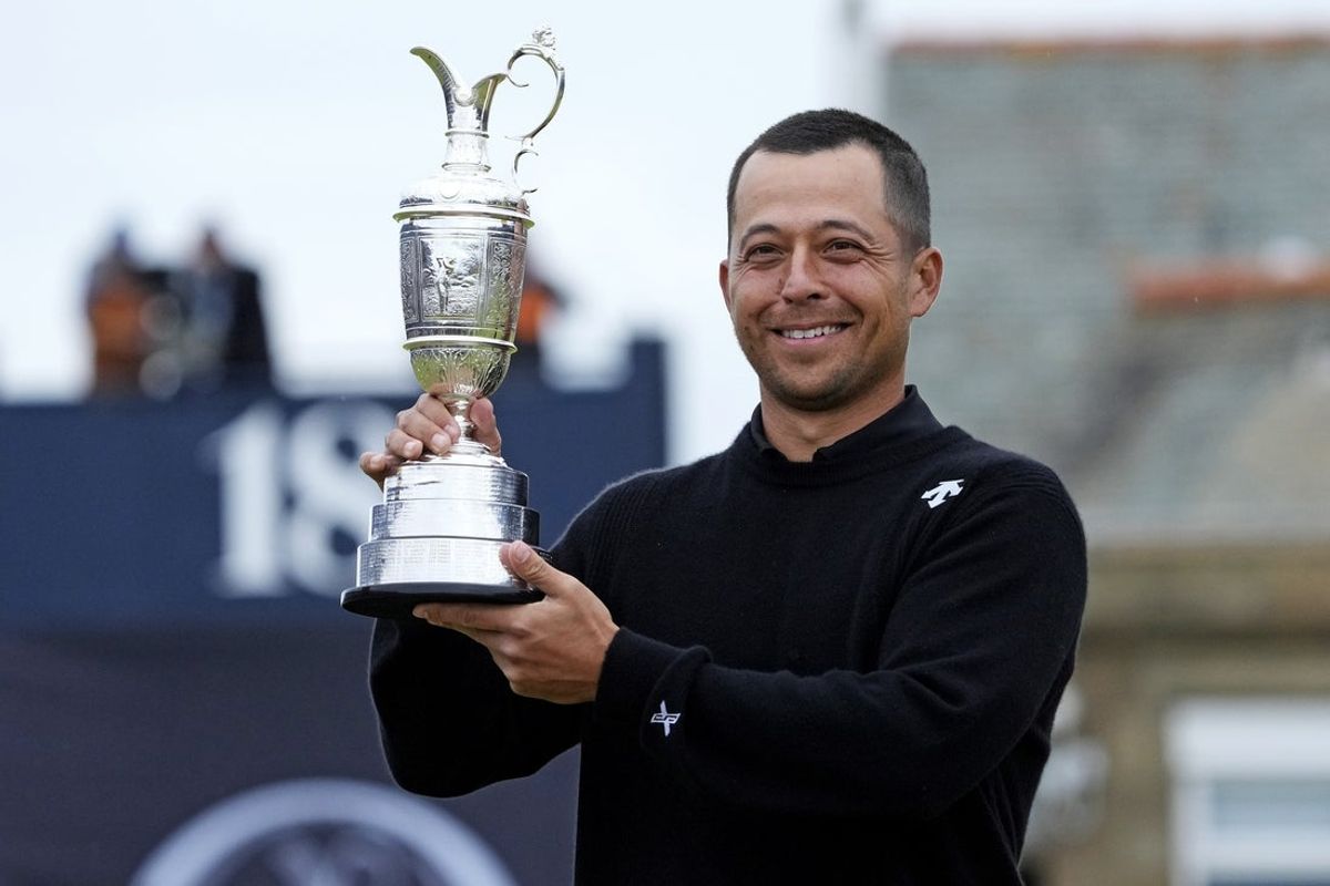 Jul 21, 2024; Ayrshire, SCT; Xander Schauffele celebrates with Claret Jug after winning the Open Championship golf tournament at Royal Troon. Mandatory Credit: Jack Gruber-Imagn Images