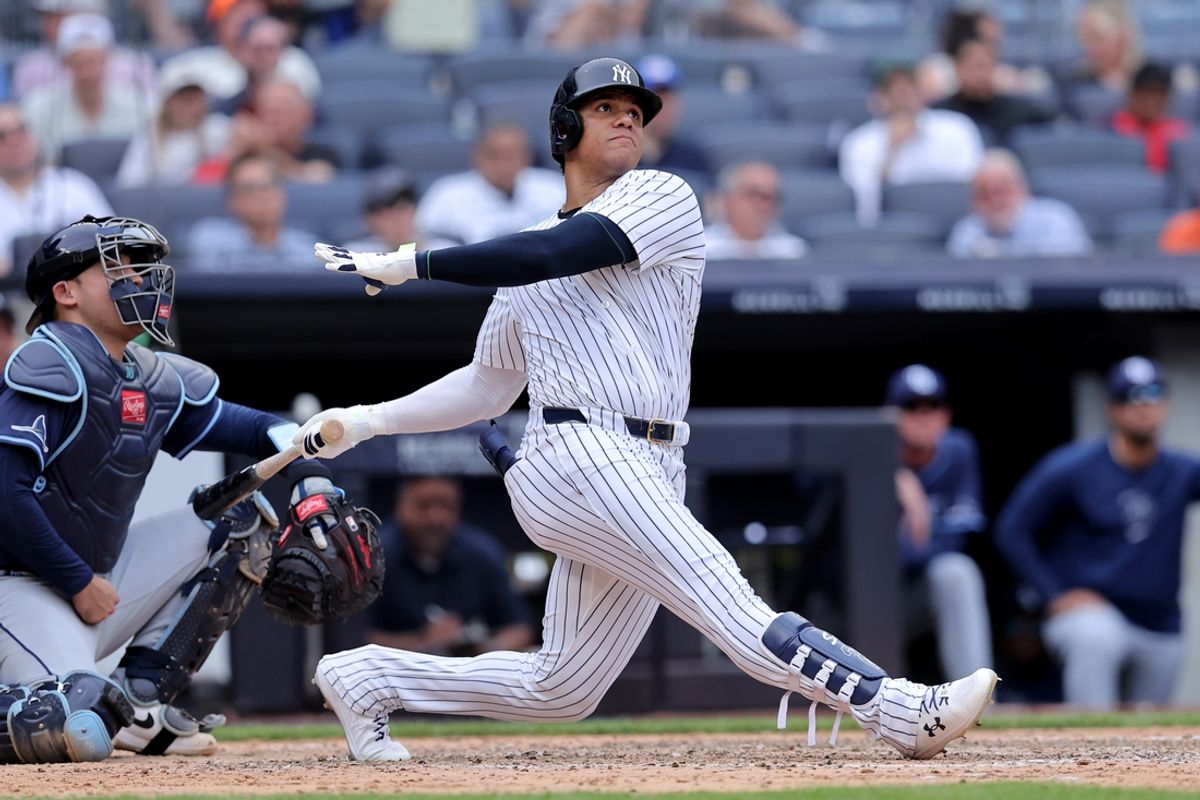 Jul 22, 2024; Bronx, New York, USA; New York Yankees right fielder Juan Soto (22) follows through on a solo home run against the Tampa Bay Rays during the seventh inning at Yankee Stadium. Mandatory Credit: Brad Penner-USA TODAY Sports