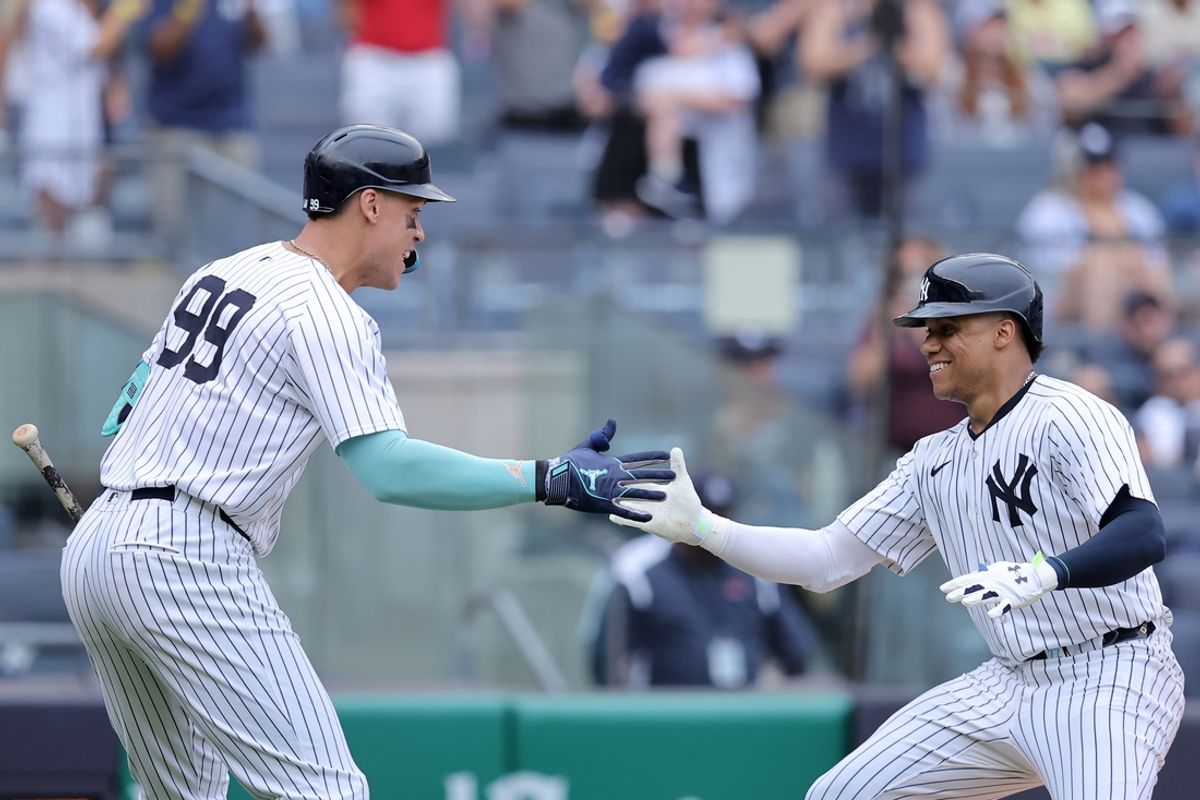 Jul 22, 2024; Bronx, New York, USA; New York Yankees right fielder Juan Soto (22) celebrates his three run home run against the Tampa Bay Rays with designated hitter Aaron Judge (99) during the eighth inning at Yankee Stadium. Mandatory Credit: Brad Penner-USA TODAY Sports