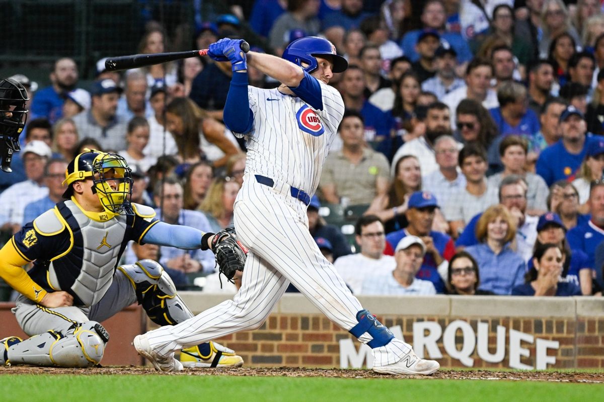 Jul 22, 2024; Chicago, Illinois, USA;  Chicago Cubs first base Michael Busch (29) hits an RBI single against the Milwaukee Brewers during the third inning at Wrigley Field. Mandatory Credit: Matt Marton-USA TODAY Sports
