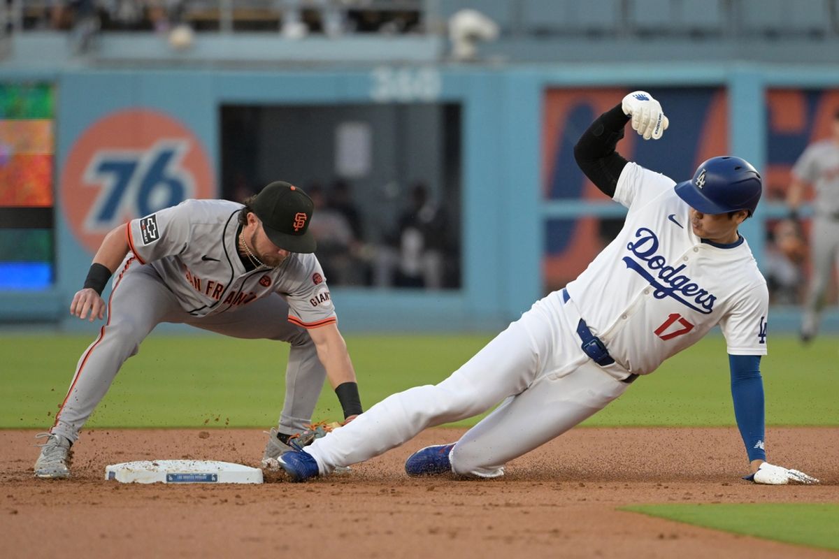 Jul 22, 2024; Los Angeles, California, USA;  Los Angeles Dodgers designated hitter Shohei Ohtani (17) is caught stealing on a tag by San Francisco Giants shortstop Brett Wisely (0) in the first inning at Dodger Stadium. Mandatory Credit: Jayne Kamin-Oncea-USA TODAY Sports