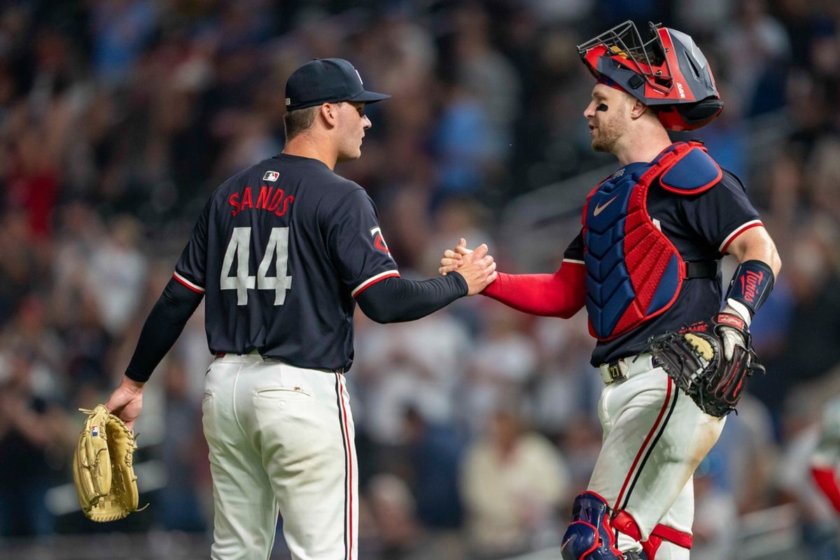 Jul 22, 2024; Minneapolis, Minnesota, USA; Minnesota Twins pitcher Cole Sands (44) and catcher Ryan Jeffers (27) celebrate after defeating the Philadelphia Phillies at Target Field. Mandatory Credit: Jesse Johnson-USA TODAY Sports