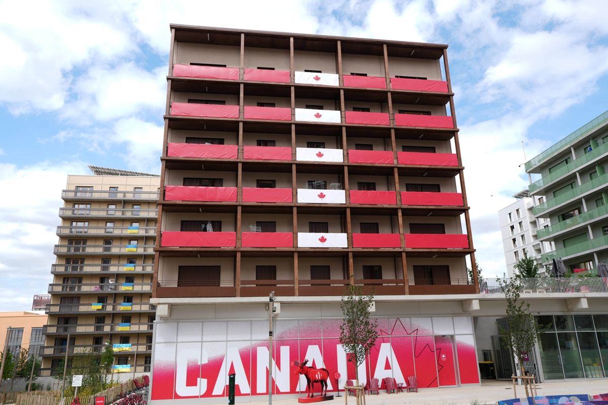 Jul 23, 2024, Saint-Denis, France; Canadian flags adorn the balconies of the Canada team residence building at the 2024 Paris Olympics athlete village. Mandatory Credit: Kirby Lee-USA TODAY Sports