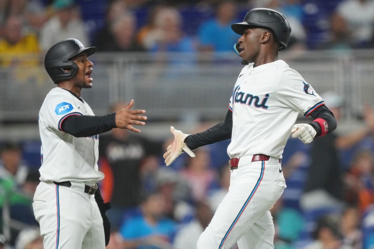 Jul 23, 2024; Miami, Florida, USA;  Miami Marlins second baseman Otto Lopez, left, congratulates left fielder Nick Gordon (1) after scoring a run in the second inning against the Baltimore Orioles at loanDepot Park. Mandatory Credit: Jim Rassol-USA TODAY Sports