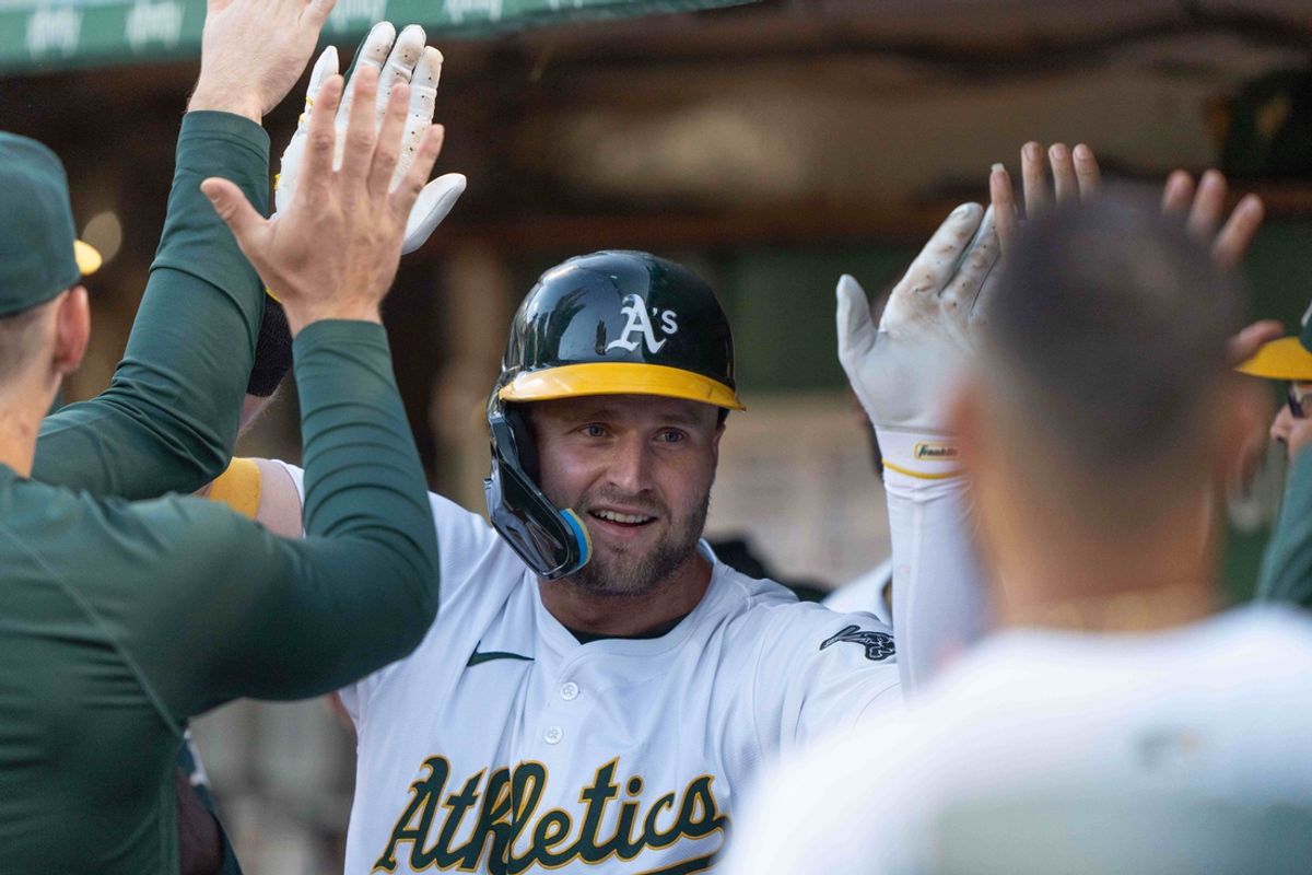 Jul 23, 2024; Oakland, California, USA;  Oakland Athletics outfielder Seth Brown (15) celebrates in the dugout after hitting a solo home run during the fourth inning against the Houston Astros at Oakland-Alameda County Coliseum. Mandatory Credit: Stan Szeto-USA TODAY Sports