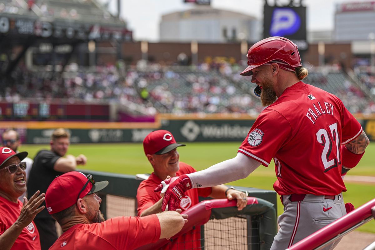 Jul 24, 2024; Cumberland, Georgia, USA; Cincinnati Reds left fielder Jake Fraley (27) reacts at the dugout after hitting a two-run home run against the Atlanta Braves during the first inning at Truist Park. Mandatory Credit: Dale Zanine-USA TODAY Sports