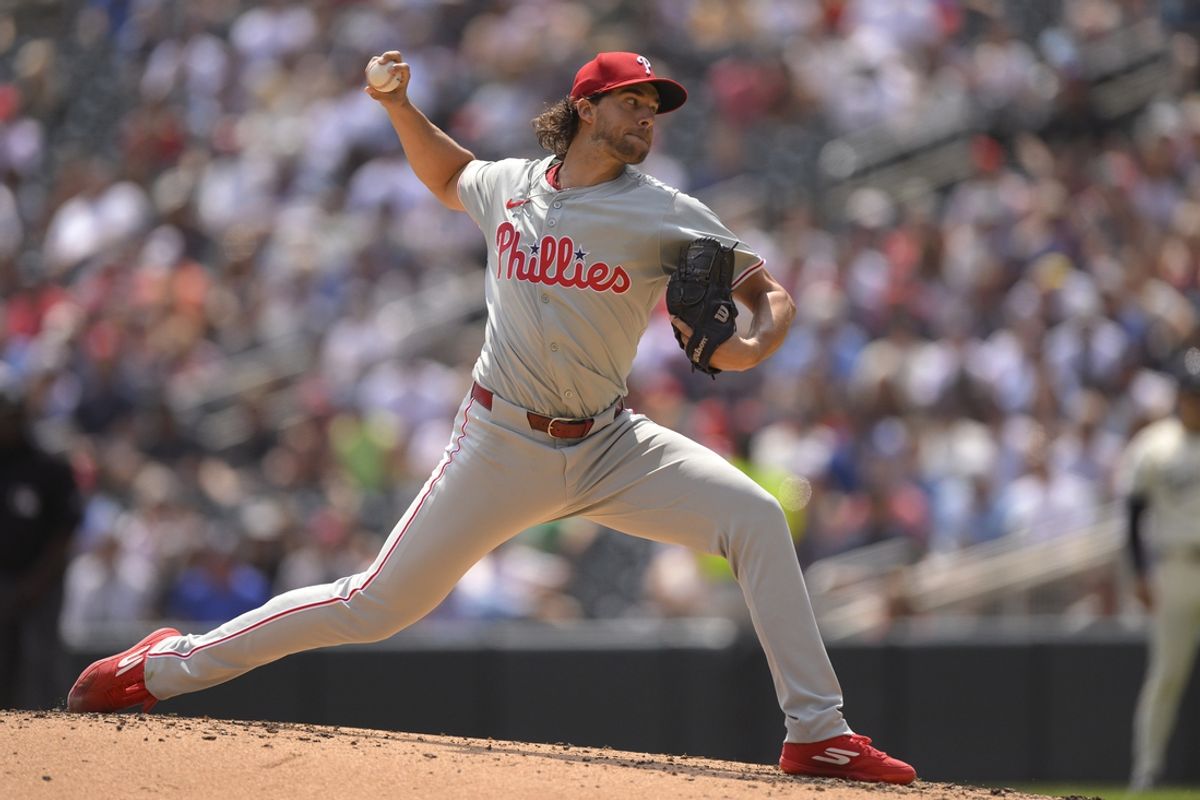 Jul 24, 2024; Minneapolis, Minnesota, USA;  Philadelphia Phillies starting pitcher Aaron Nola (27) delivers a pitch against the Minnesota Twins during the first inning at Target Field. Mandatory Credit: Nick Wosika-USA TODAY Sports