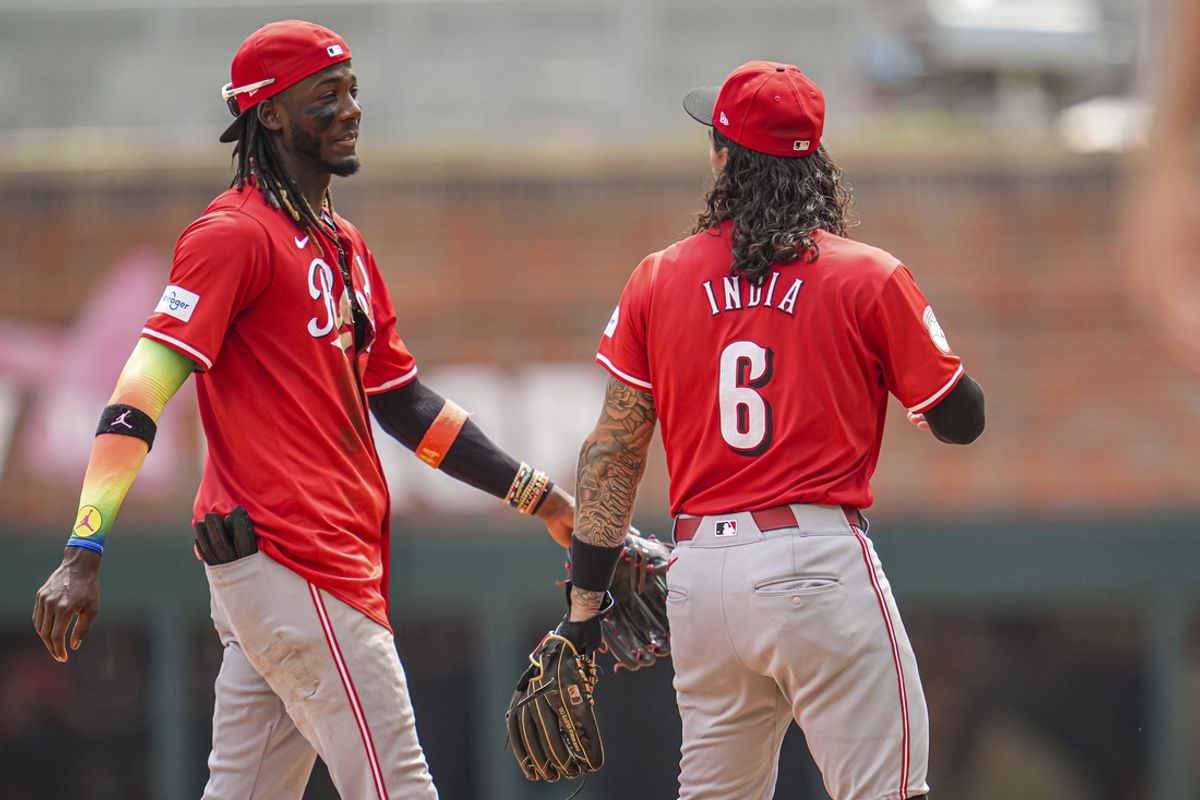 Jul 24, 2024; Cumberland, Georgia, USA; Cincinnati Reds shortstop Elly De La Cruz (44) and second baseman Jonathan India (6) react after the Reds defeated the Atlanta Braves at Truist Park. Mandatory Credit: Dale Zanine-USA TODAY Sports
