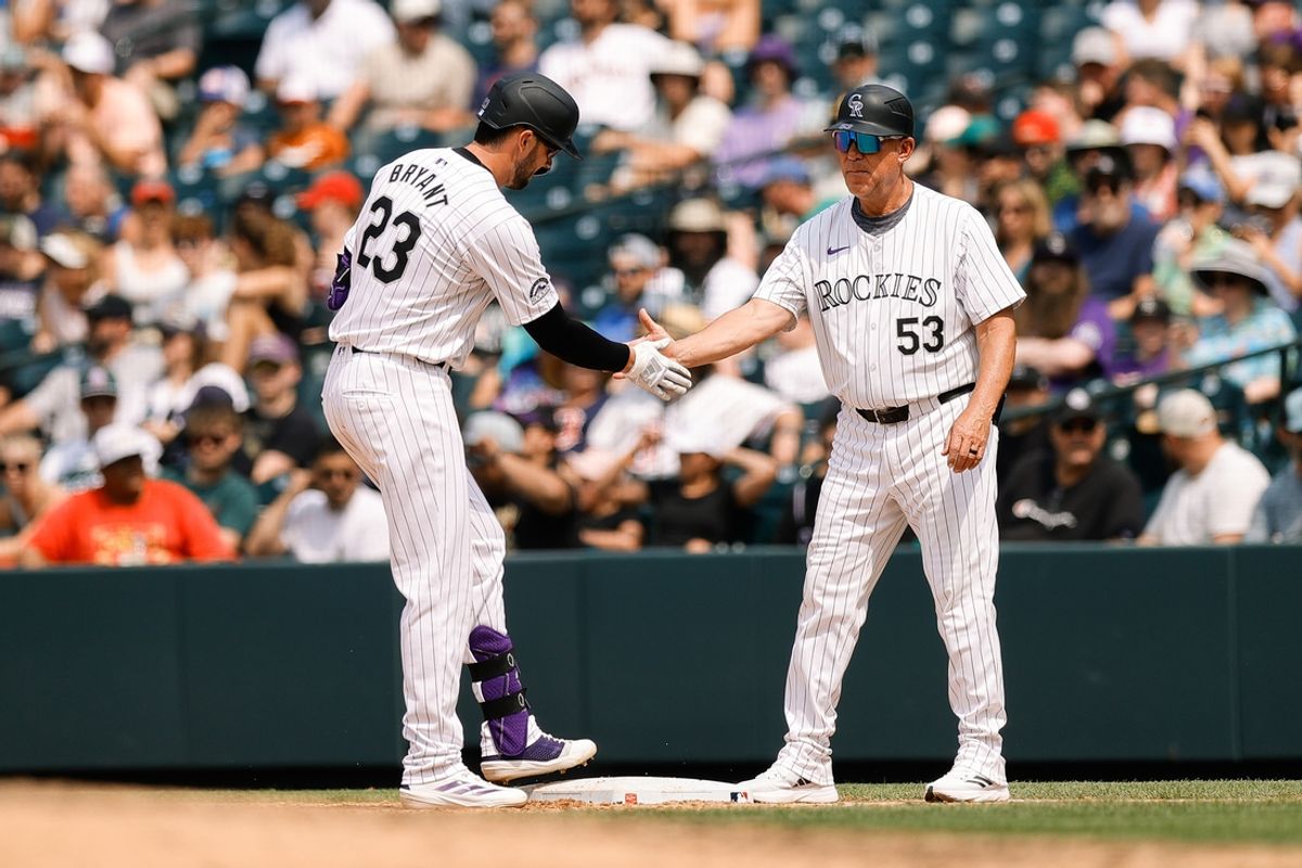 Jul 24, 2024; Denver, Colorado, USA; Colorado Rockies designated hitter Kris Bryant (23) reacts with first base coach Ronnie Gideon (53) after a single in the sixth inning against the Boston Red Sox at Coors Field. Mandatory Credit: Isaiah J. Downing-USA TODAY Sports